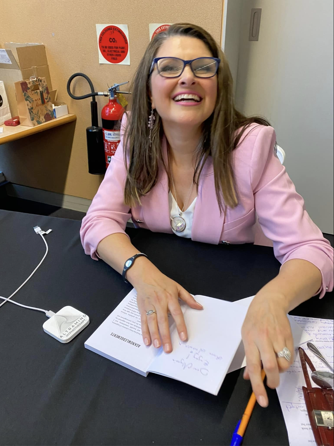 Natalie signing a book